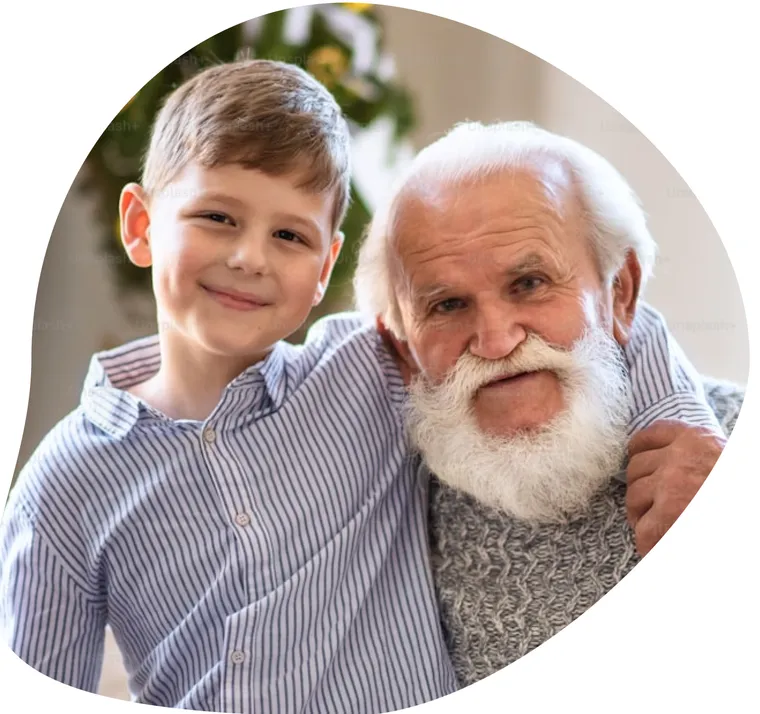 A grandfather with his arm around his smiling grandson